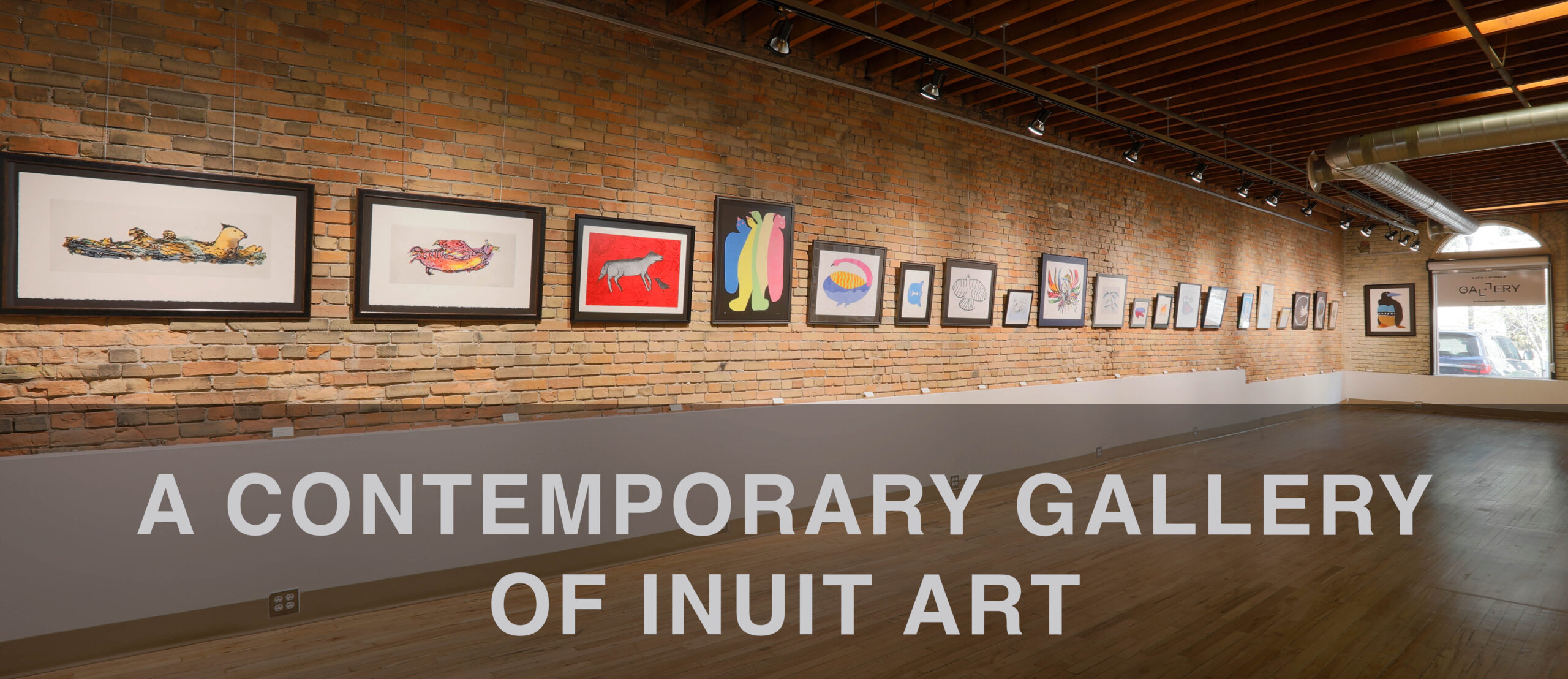 Katie and Gunner Gallery - brick wall with Inuit art hanging - with text
