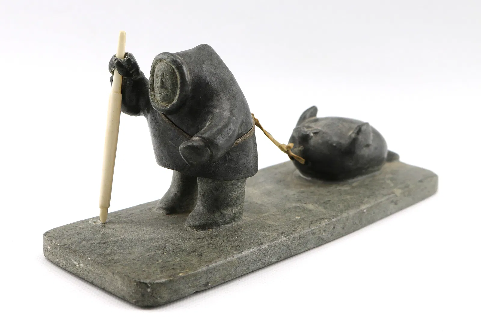 Hunter Pulling Seal-sculpture by Sammy Nassak-view1 Hunter Pulling Seal - sculpture by Inuit artist Sammy Nassak